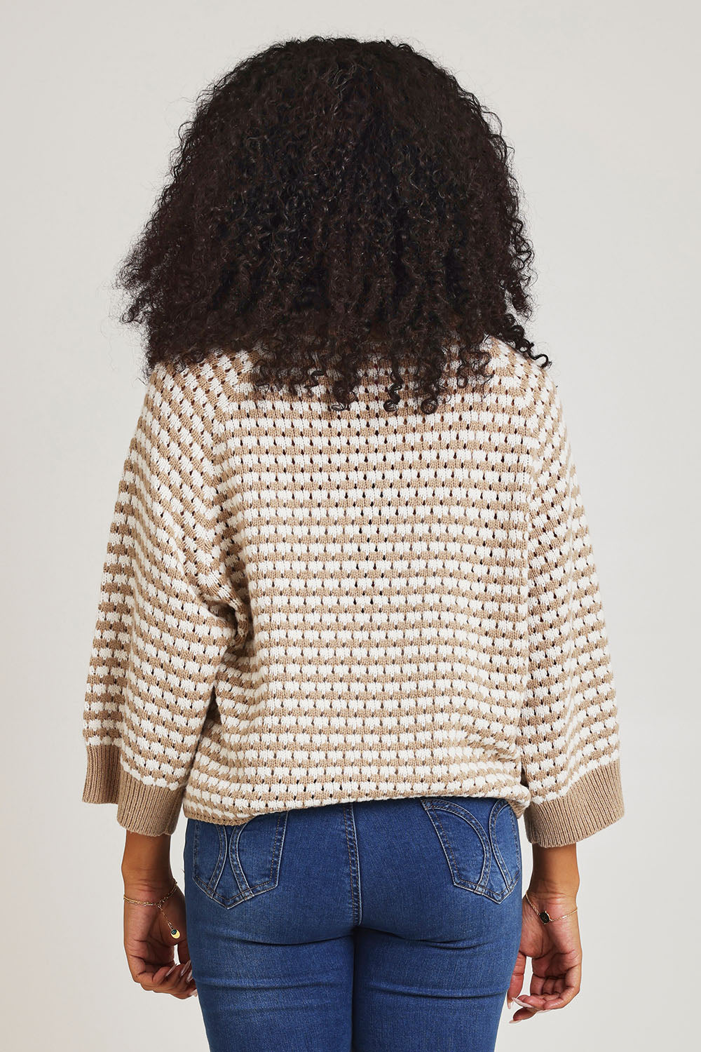 Model Ziara wearing size S of the Texture Cotton Merino Jumper in colour Camel, from the back
