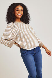 Model Ziara wearing size S of the Texture Cotton Merino Jumper in colour Camel, from the front, cropped image