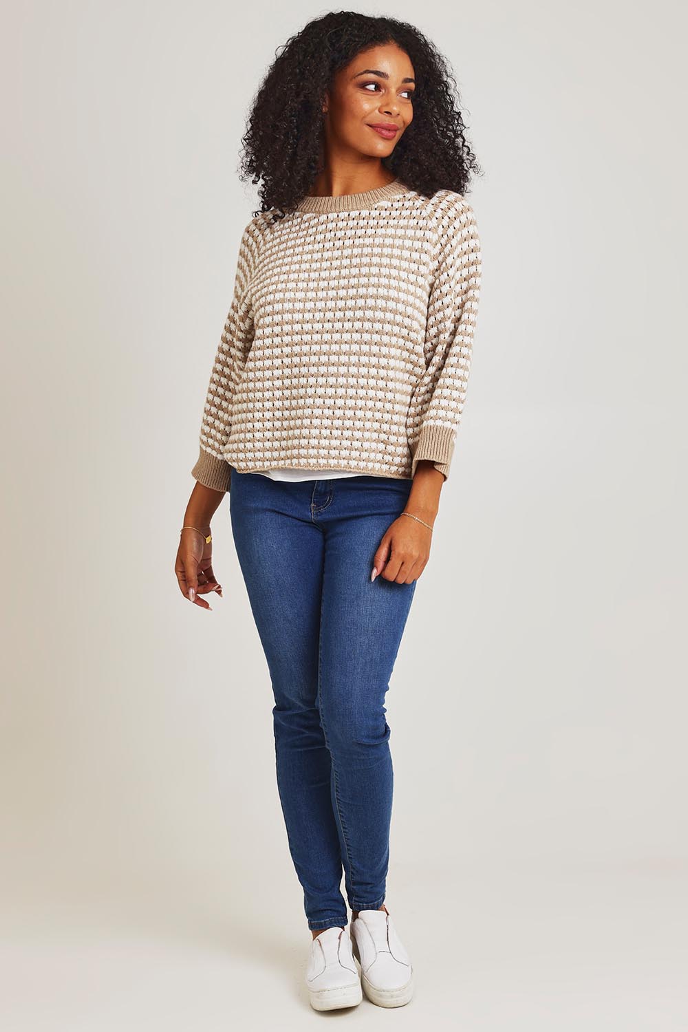 Model Ziara wearing size S of the Texture Cotton Merino Jumper in colour Camel, from the front, showing the whole outfit