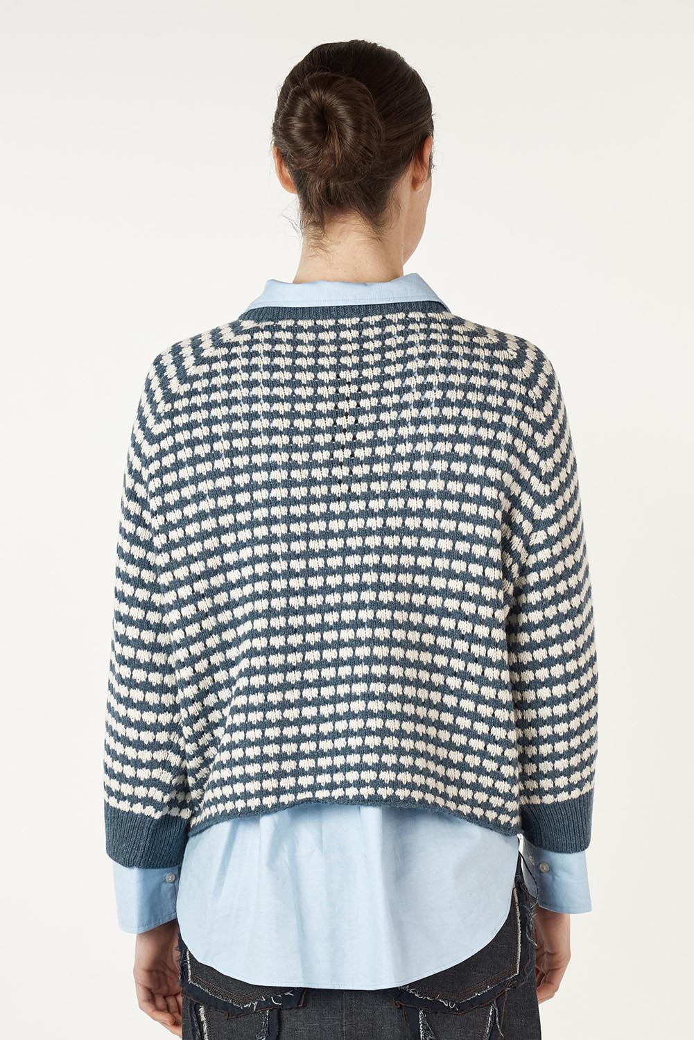 A model wearing the Texture Cotton Merino Jumper in colour Denim (Blue), from the back