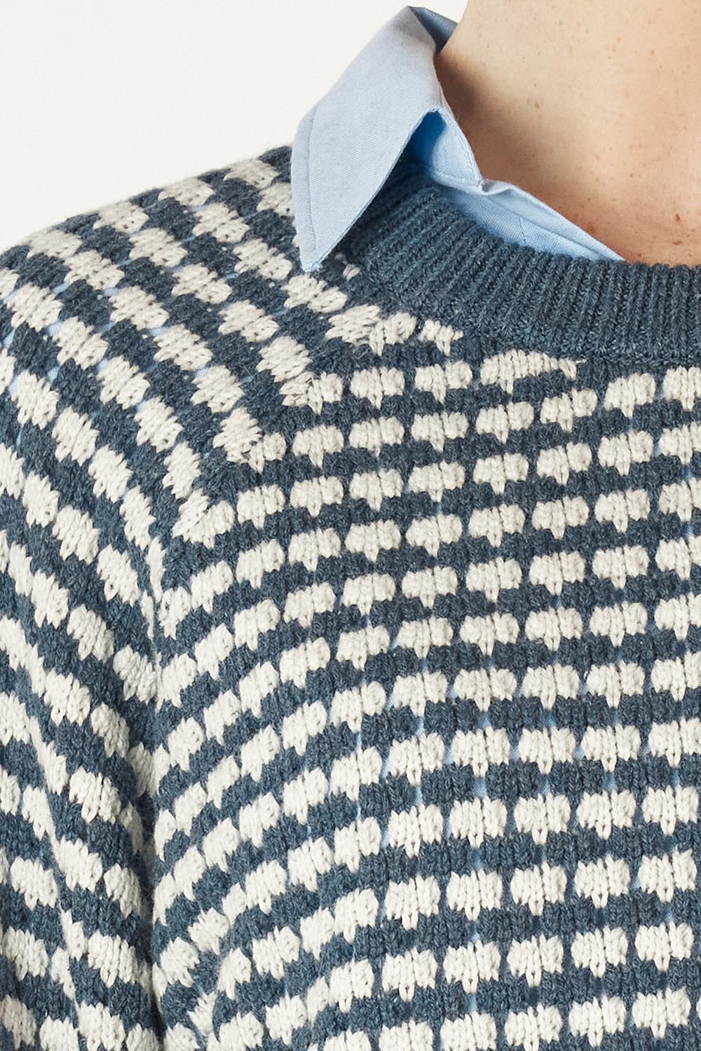 A model wearing the Texture Cotton Merino Jumper in colour Denim (Blue), from the front, cropped image