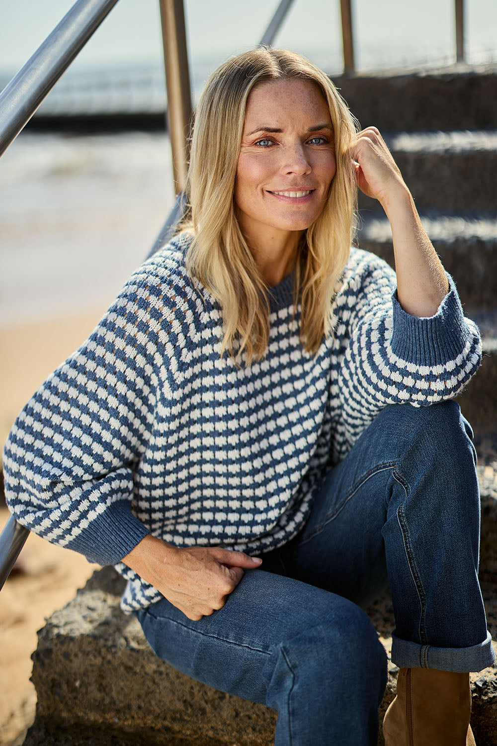Model Maggie wearing size S of the Texture Cotton Merino Jumper in colour Denim (Blue), from the front, showing the whole outfit