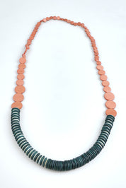 A model wearing the Laroda Wooden Necklace in colour Pinkteal, from the front, showing the whole outfit