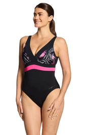 A model wearing the Square Back One Piece in colour Safari (Black), from the front, cropped image